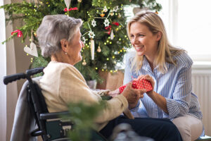 caregiver-sharing-gift-with-disabled-Alzheimers-senior