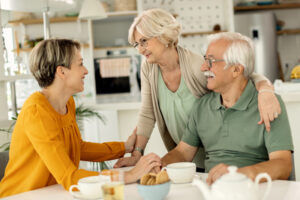 family caregiver with happy senior couple