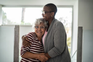 A woman embraces her senior mother after using strategies for managing senior anxiety.